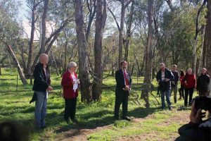 Desrae Clarke speaking at the opening of the John Masters Bird Hide (mulitple people standing and listening)