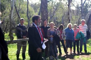 The Toodyay Shire president, Kevin Hogg, speaking at the opening of the John Masters Bird Hide (mulitple people standing and listening)